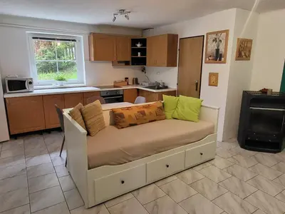 a living room with a couch in a kitchen at Ubytování na kopečku in Beroun