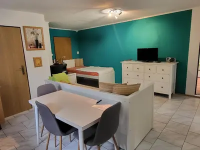 a room with a bed and a table and chairs at Ubytování na kopečku in Beroun