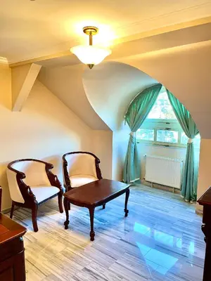 a room with a table and two chairs and a window at Palace Inn in Jíloviště