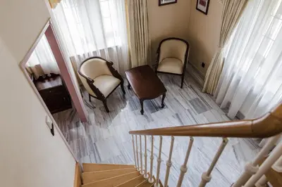 an overhead view of a staircase with chairs and a table at Palace Inn in Jíloviště