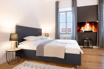 a bedroom with a large bed with a fireplace at U Zlaté hvězdy Ritz in Litoměřice