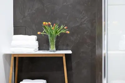 a vase of flowers on a table in a bathroom at U Zlaté hvězdy Ritz in Litoměřice