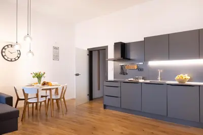 a kitchen and dining room with a table and chairs at U Zlaté hvězdy Ritz in Litoměřice