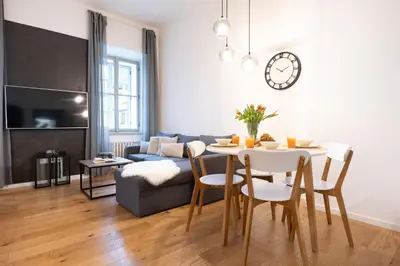 a living room with a table and a couch at U Zlaté hvězdy Ritz in Litoměřice