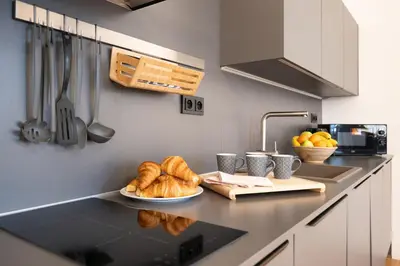 a kitchen with bread and croissants on a counter at U Zlaté hvězdy Ritz in Litoměřice
