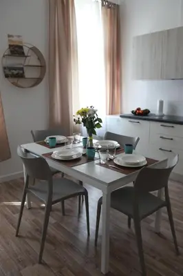 a white table with chairs and plates and flowers on it at Arbes 12 in Prague