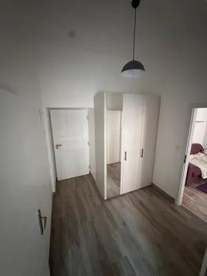 an empty room with white walls and wooden floors at Arbes 12 in Prague