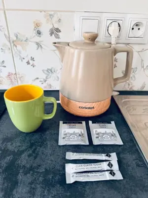 a coffee pot sitting next to a cup on a counter at Arbes 12 in Prague