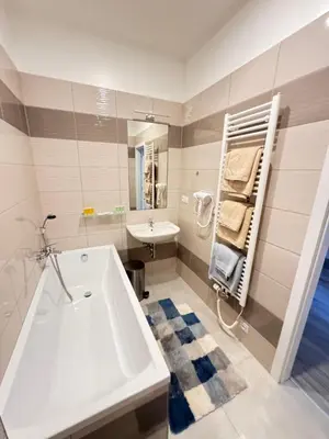 a bathroom with a white tub and a sink at Arbes 12 in Prague