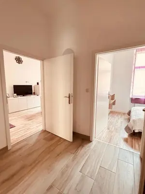 an empty living room with an open door at Arbes 12 in Prague