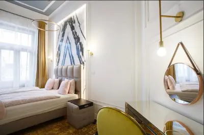 a bedroom with a bed and a mirror at Urban Premier Suite in Prague