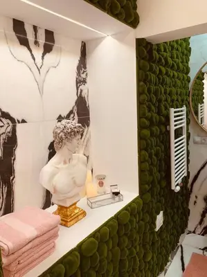 a bathroom with a statue of a man in a mirror at Urban Premier Suite in Prague