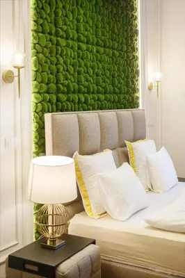a room with a bed with a green wall at Urban Premier Suite in Prague