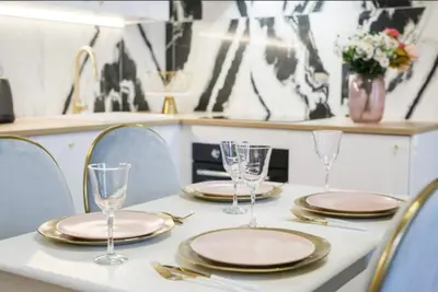 a table with plates and wine glasses on it at Urban Premier Suite in Prague