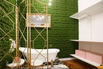 a bathroom with a green wall with a white bath tub at Urban Presidential Suite in Prague
