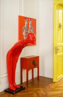 a red statue of a woman bending over a table at Urban Presidential Suite in Prague