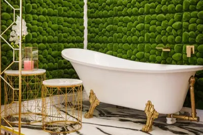 a bathroom with a tub and a green wall at Urban Presidential Suite in Prague
