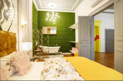 a bedroom with a bed and a green wall at Urban Presidential Suite in Prague