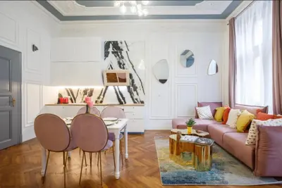 a living room with a couch and a table and chairs at Urban Presidential Suite in Prague
