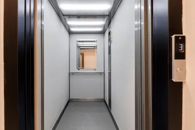 a corridor of an elevator with a mirror at New Town Oases Apartment in Prague