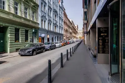 a row of cars parked on a street with buildings at New Town Oases Apartment in Prague