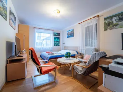 a living room with a bed and a table and chairs at Holiday Home Vrbová Lhota U Aničky by Interhome in Vrbová Lhota