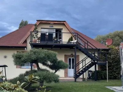 a house with a balcony and a staircase at Holiday Home Vrbová Lhota U Aničky by Interhome in Vrbová Lhota