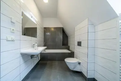 a bathroom with a toilet and a sink and a tub at Villa Mandát in Šlemín
