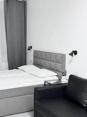 a bedroom with a bed and a table and a couch at NEW Modern Large Apartment in New Town 3BDR in Prague