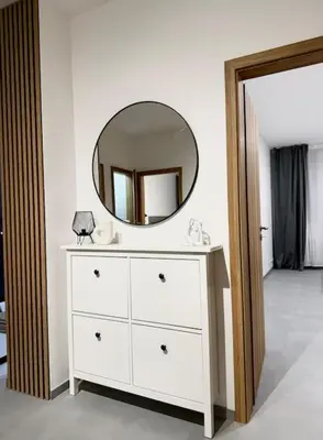 a white dresser with a mirror on top of it at NEW Modern Large Apartment in New Town 3BDR in Prague