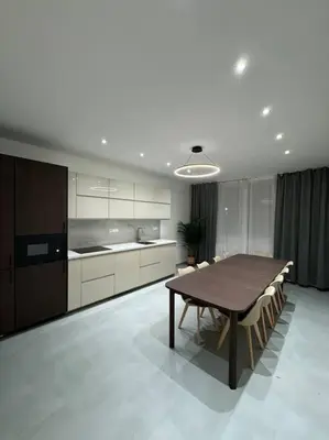 a kitchen with a wooden table and a dining room at NEW Modern Large Apartment in New Town 3BDR in Prague