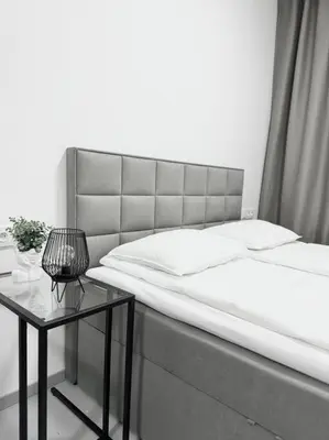 a bedroom with a large bed and a table at NEW Modern Large Apartment in New Town 3BDR in Prague