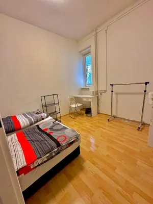 a bedroom with a bed and a desk in it at Bene Dormies in Prague