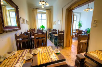 a dining room with wooden tables and chairs at Wenceslas Square Hotel - Czech Leading Hotels in Prague