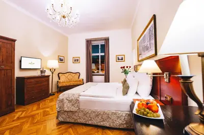 a hotel room with a bed and a bowl of fruit at Wenceslas Square Hotel - Czech Leading Hotels in Prague
