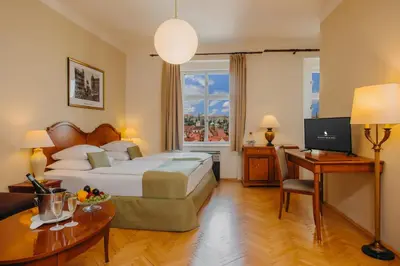 a hotel room with a bed and a desk at Wenceslas Square Hotel - Czech Leading Hotels in Prague
