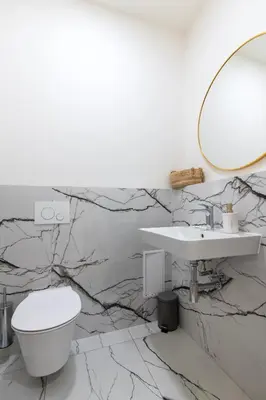 a bathroom with a white toilet and a sink at Arch IV. in Prague