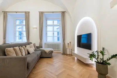 a living room with a couch and a tv at Arch IV. in Prague