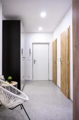 an empty hallway with a door and a chair at Jana's WoW apt, 2BR, Metro next door, near the airport in Prague