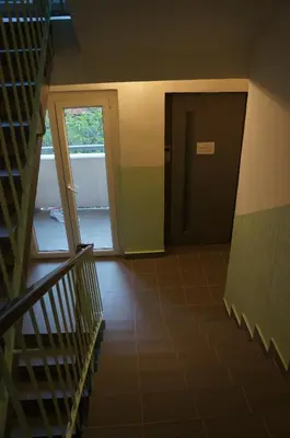 an empty hallway with a staircase and a door at Jana's WoW apt, 2BR, Metro next door, near the airport in Prague
