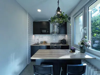 a kitchen with a wooden counter top and a window at Jana's WoW apt, 2BR, Metro next door, near the airport in Prague