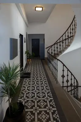 a hallway with a tile floor and a staircase at Penzion Apartmány Resident in Poděbrady