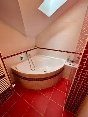 a bathroom with a large tub in a red floor at Great spacious villa near Prague in Božkov