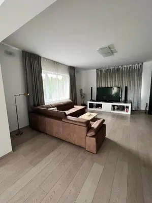 a living room with a couch and a television at Great spacious villa near Prague in Božkov