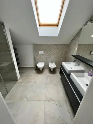 a bathroom with two sinks and a skylight at Great spacious villa near Prague in Božkov