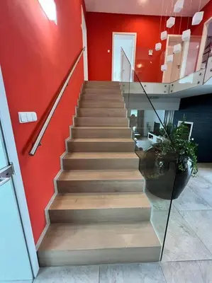 a staircase in a room with a red wall at Great spacious villa near Prague in Božkov
