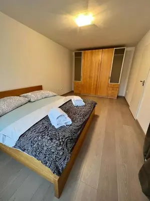 a bedroom with a bed with two towels on it at Great spacious villa near Prague in Božkov