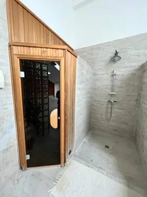 a bathroom with a shower and a glass door at Great spacious villa near Prague in Božkov