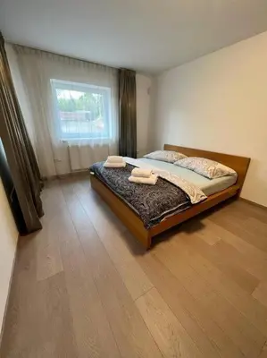 a bedroom with a bed with two towels on it at Great spacious villa near Prague in Božkov