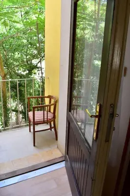 a door to a porch with a chair on a balcony at Authentic, traditional airbnb in central Prague ! in Prague